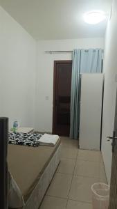 a bedroom with a bed and a door and a room with a door at Dragon Golden Homes in Dubai