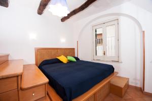 a bedroom with a bed and a window at Casa Ermelinda in Amalfi