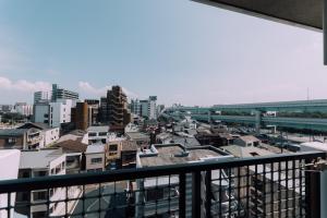 una vista di una città da un balcone di New! Japandi 3 1BR in Prime Location-1 min to STN a Hakata