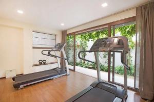 a gym with a treadmill and a large window at Six Hills Villa - A Private Sanctuary of Elegance in Amphoe Koh Samui