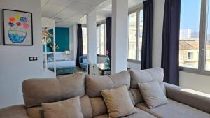 a living room with a brown couch in a room at Felix Saenz Boutiques Suites by Del Parque Flats in Málaga