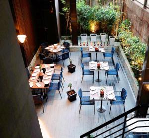 a group of tables and chairs on a patio at THE WAY Dhaka in Dhaka