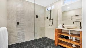 a bathroom with a sink and a shower at The Loft in Culburra Beach +16 photos
