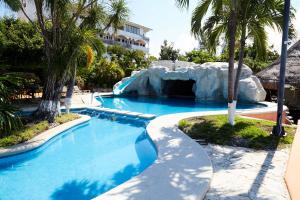 a pool at a resort with a fake waterfall at Yacht House in Cancún