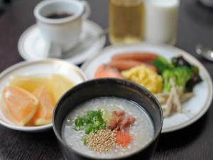 a table with a bowl of soup and a plate of food at Smile Hotel Okinawa Naha (Tomari Port) in Naha