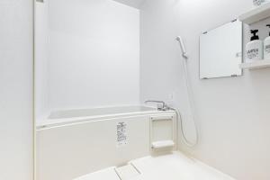 a white bathroom with a sink and a mirror at -Park Higashiueno301- 4-minute walk from Ueno Station in Tokyo