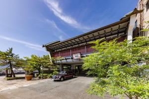 a building with a car parked in front of it at Kyotoya in Takeo