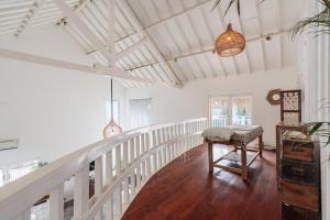 a white hallway with a table and a chair at European-Inspired Villa Near Beach & Dining in Gili Trawangan +24 photos