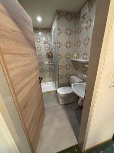 a bathroom with a toilet and a sink at Frühstückspension Danklmaier in Assachberg +19 photos