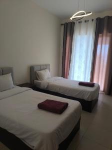 a hotel room with two beds and a window at EP4 Samarah Resort in Sowayma
