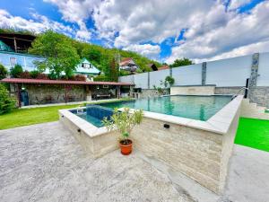 a swimming pool in the backyard of a house at Casa Verde in Orşova