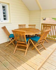 a wooden table and chairs on a porch at Bungalow Carioca in Le Robert