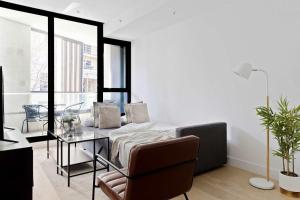 una sala de estar con un sofá y una mesa en A Cozy 2BR Apt Right on Buzzing Chapel Street, en Melbourne