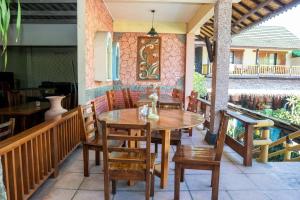 a wooden table and chairs on a patio at Grand Desa Resort in Cimaja