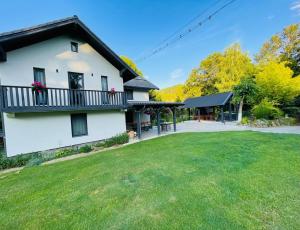 a white house with a balcony and a yard at Cabana Patric Valea Avrigului in Avrig +119 photos