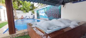 a bath tub filled with snow next to a swimming pool at Villa Luz in Andrés +6 photos
