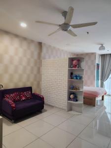 a living room with a couch and a bed at Cozy Stay - Atria Sofo in Damansara Jaya in Petaling Jaya