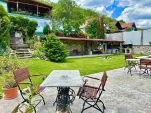 a patio with a table and chairs in a yard at Casa Verde in Orşova