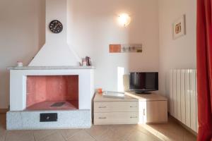 a living room with a fireplace and a tv at New Vista Blu Alghero in Alghero