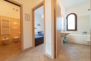 a bathroom with a tub and a toilet and a sink at New Vista Blu Alghero in Alghero +42 photos