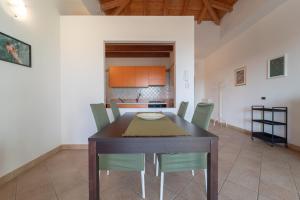 a kitchen and dining room with a table and chairs at New Vista Blu Alghero in Alghero