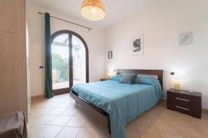 a bedroom with a large bed with a large window at New Vista Blu Alghero in Alghero