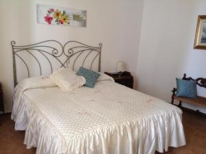 a bedroom with a bed with a white comforter at Casa Del Mulino in Levanto