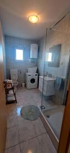a bathroom with a shower and a toilet and a sink at Apartments Duje in Bibinje