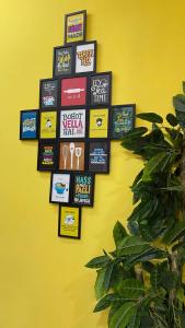 a wall with a bunch of signs on a yellow wall at Sweet Home Guest House in Islamabad