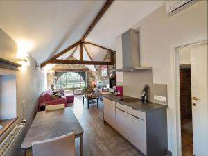 a kitchen and living room in a loft at Clos Du Ry De Snaye in Beauraing