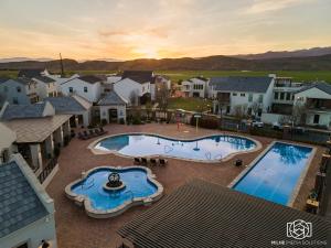 an aerial view of a house with two swimming pools at The Ella home in Hurricane +39 photos
