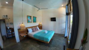 Postel nebo postele na pokoji v ubytování Yapak Beach Villas