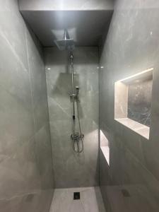 a bathroom with a shower with a glass door at Near Finikoudes beach 1 in Larnaka +12 photos