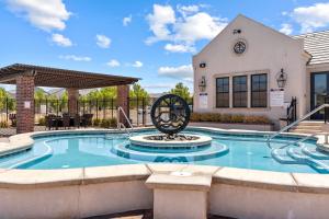 a pool with a metal sculpture in front of a building at Highlander townhouse in Hurricane +45 photos