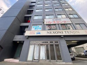 a building with a sign on the side of it at Nexoni Tenjin in Fukuoka