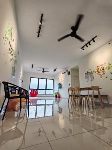 a dining room with chairs and a ceiling fan at APPLE CloverLeafs Homestay Melaka in Melaka
