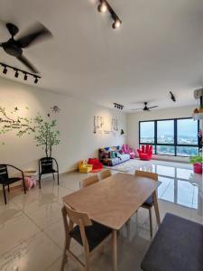 a living room with a table and chairs at APPLE CloverLeafs Homestay Melaka in Melaka
