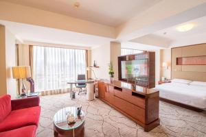 a hotel room with a bed and a television at Jinan Silver Plaza Quancheng Hotel in Jinan +191 photos
