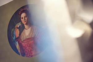 a painting of a woman in a red dress in a mirror at LeonArt Living 42 in Graz