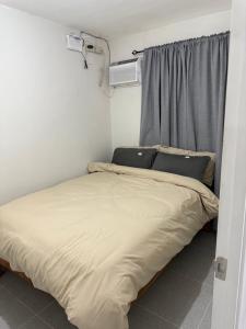 a bed in a small room with a window at JV tRansient 24 in Ormoc