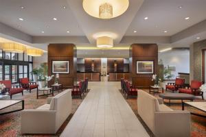 a lobby of a hotel with chairs and tables at Ramada Plaza by Wyndham Orlando Resort & Suites Intl Drive - Newly Renovated! in Orlando
