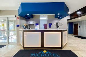 a lobby of a microsoft office with a blue ceiling at Microtel Inn & Suites by Wyndham Columbia in Columbia
