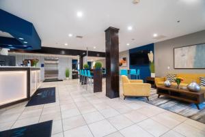a living room and a kitchen with blue walls at Microtel Inn & Suites by Wyndham Columbia in Columbia