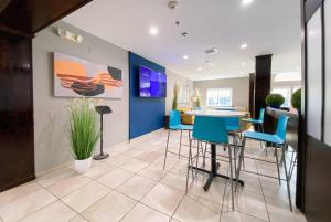 a living room with a table and chairs at Microtel Inn & Suites by Wyndham Columbia in Columbia