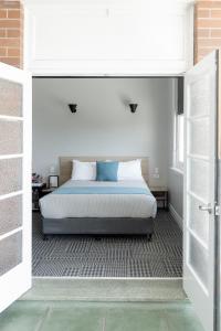 a bed in a room with a door open at Tourist Hotel Narrabri in Narrabri