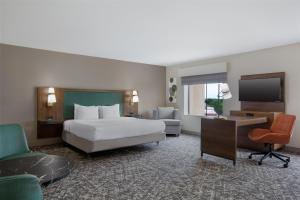 a hotel room with a bed and a desk and a television at Hampton Inn & Suites Dallas-Arlington North-Entertainment District in Arlington