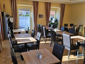 a dining room with wooden tables and chairs at Hotel Kirchenwirt in Bad Kleinkirchheim