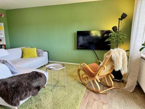 a living room with a dog sitting in a chair at Ferienwohnung Fichtel-STEIN in Fichtelberg