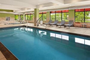 a large swimming pool with blue water in a building at Hampton Inn Minneapolis-Roseville,MN in Roseville