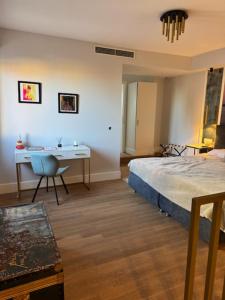 a bedroom with a bed and a desk and a table at Casa Del Telegrafo in Labin